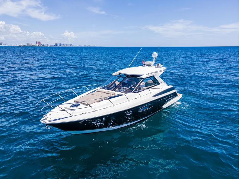 Slide: The Image of 2015 Regal 42 Sport Coupe yacht cruising on open blue sea. - 22