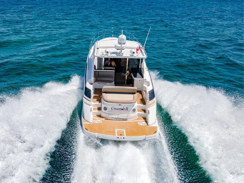 Slide: The Image of 2015 Regal 42 Sport Coupe cruising on open blue water. - 24