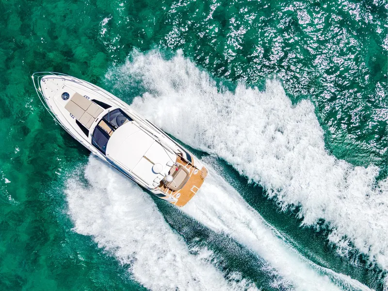 Slide: The Image of 2015 Regal 42 Sport Coupe cruising on turquoise ocean waters. - 25