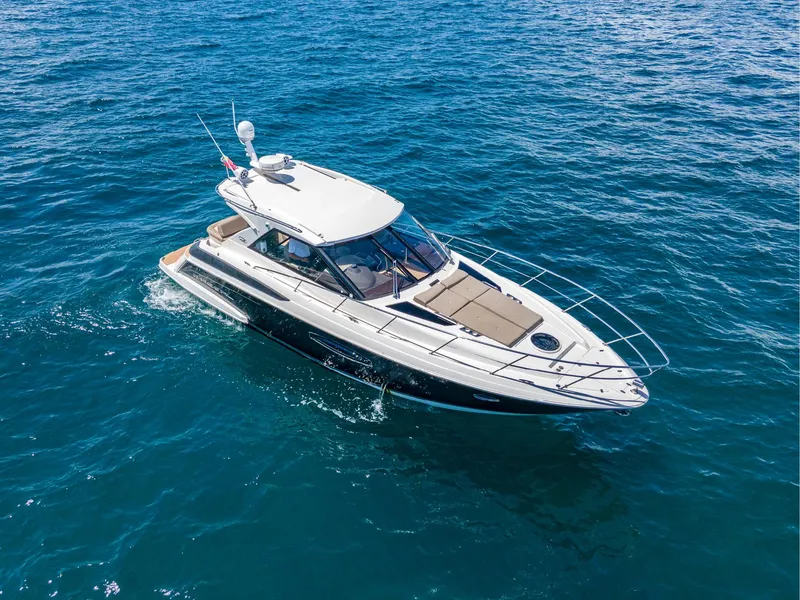 Slide: The Image of 2015 Regal 42 Sport Coupe cruising on open blue water. - 3