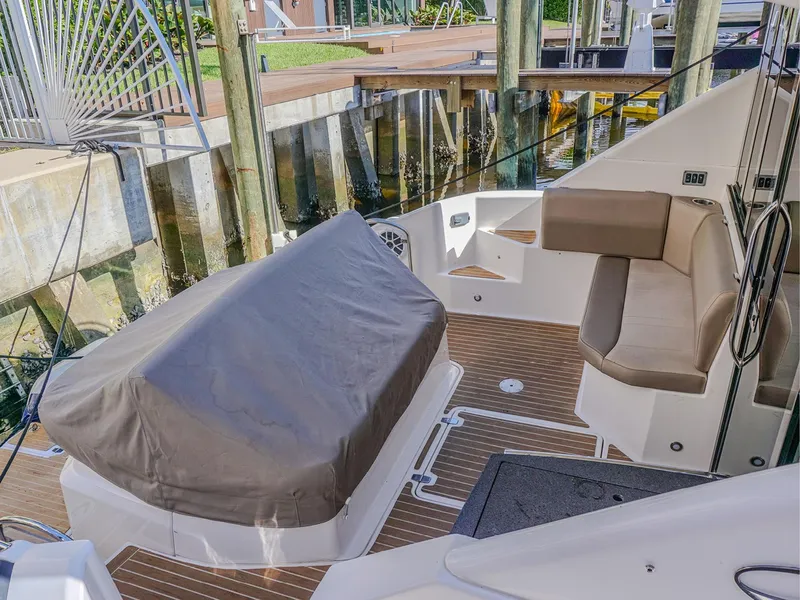 Slide: The Image of 2015 Regal 42 Sport Coupe boat deck with seating and covered equipment. - 4