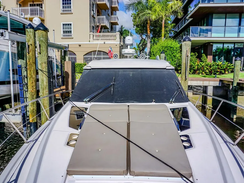 Slide: The Image of 2015 Regal 42 Sport Coupe docked near waterfront buildings. - 5