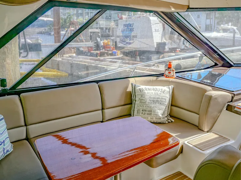 Slide: The Image of Interior of 2015 Regal 42 Sport Coupe with cozy seating and wooden table. - 7