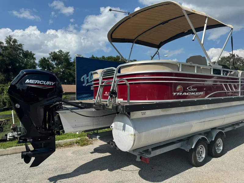 Slide: The Image of 2023 Sun Tracker Party Barge 24 DLX pontoon boat with Mercury engine on trailer. - 2