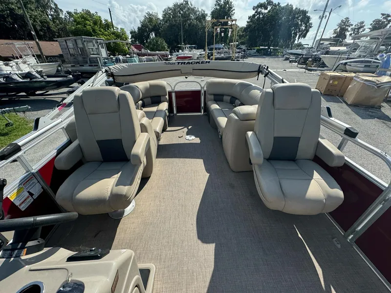 Slide: The Image of 2023 Sun Tracker Party Barge 24 DLX interior with plush seating and spacious layout. - 9