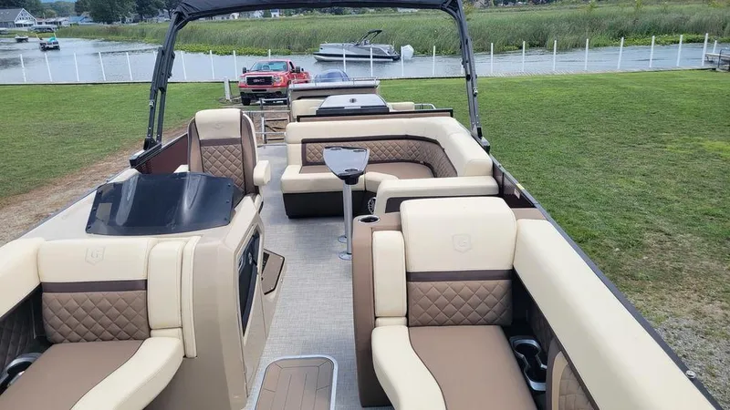 Slide: The Image of 2023 AquaPatio 275 CBE iMPACT pontoon boat with luxurious seating and modern design. - 14