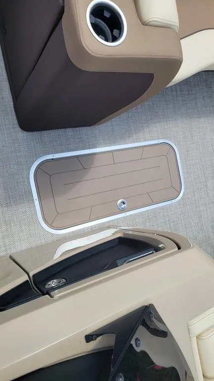 Slide: The Image of 2023 AquaPatio 275 CBE iMPACT interior with cup holder and storage compartment. - 17