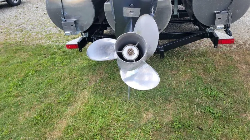 Slide: The Image of 2023 AquaPatio 275 CBE iMPACT boat propeller on grass, rear view. - 5