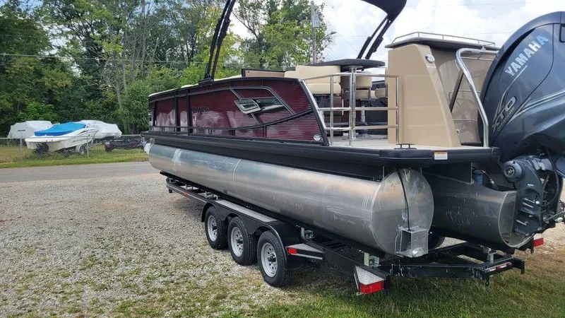 Slide: The Image of 2023 AquaPatio 275 CBE iMPACT pontoon boat on trailer, featuring Yamaha engine. - 6