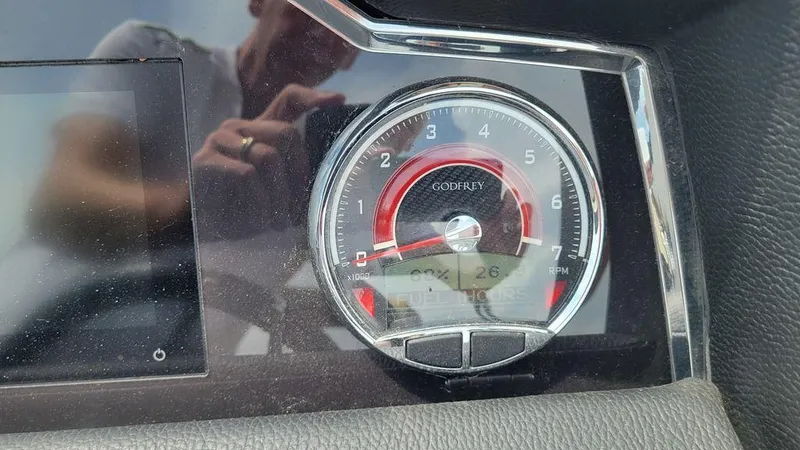 Slide: The Image of Dashboard of 2023 AquaPatio 275 CBE iMPACT boat with tachometer and digital display. - 8