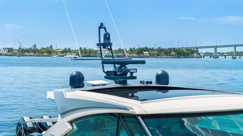 Slide: The Image of 2022 Formula 500 Super Sport Crossover yacht on serene water with clear blue sky. - 11