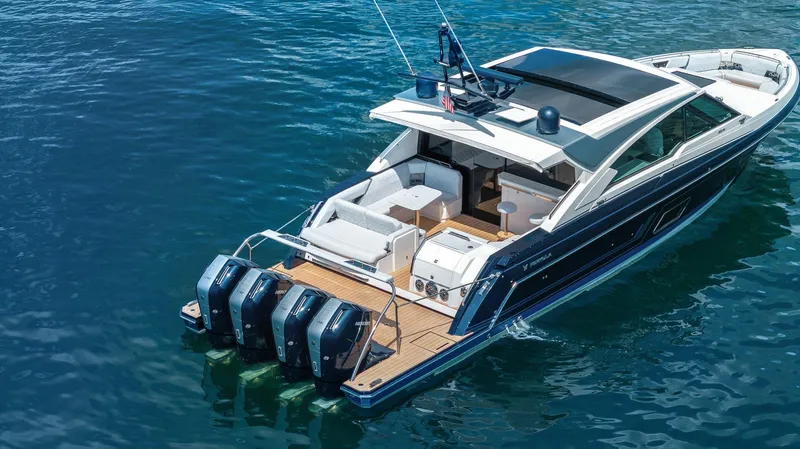 Slide: The Image of 2022 Formula 500 Super Sport Crossover luxury boat on clear blue water. - 12