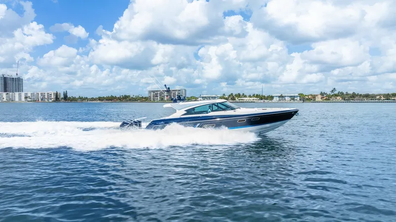 Slide: The Image of 2022 Formula 500 Super Sport Crossover cruising on a sunny day, blue sky and water. - 14