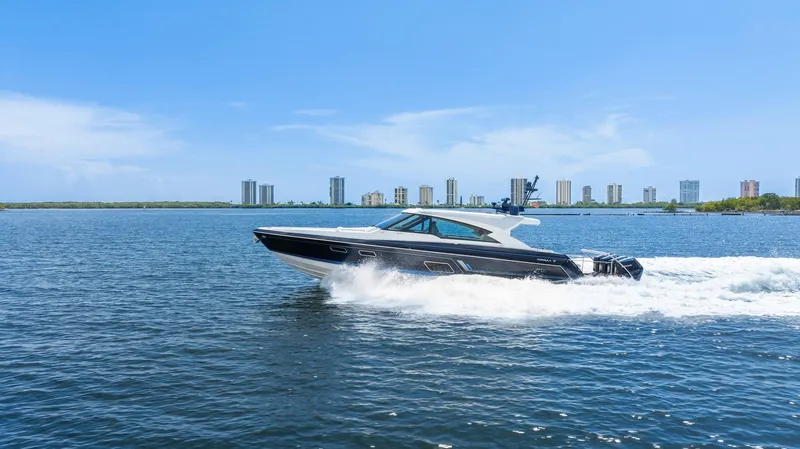 Slide: The Image of 2022 Formula 500 Super Sport Crossover cruising on a sunny day with city skyline backdrop. - 18