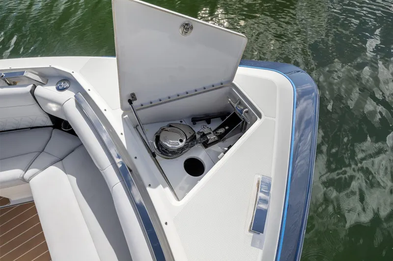 Slide: The Image of 2022 Formula 500 Super Sport Crossover boat anchor storage compartment open on water. - 26