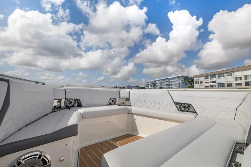 Slide: The Image of 2022 Formula 500 Super Sport Crossover boat interior with white seating under a cloudy sky. - 27