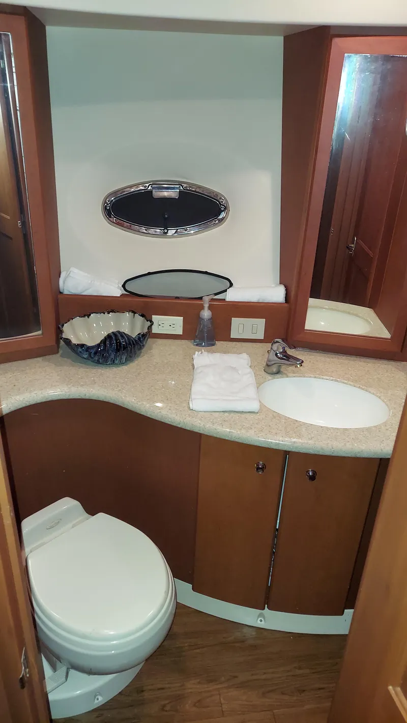 Slide: The Image of Luxurious bathroom in 2005 Silverton 43 Motor Yacht with elegant fixtures and wood cabinetry. - 19