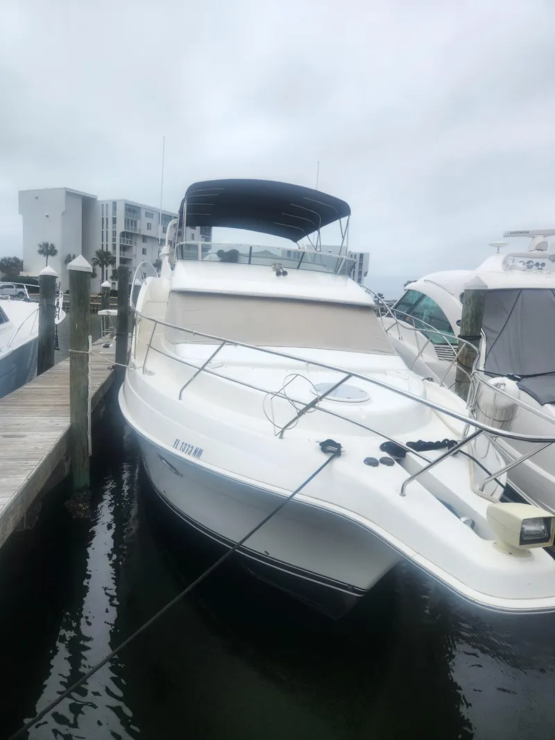 Slide: The Image of 2005 Silverton 43 Motor Yacht docked at marina on a cloudy day. - 2