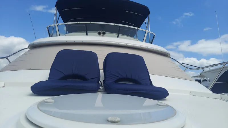 Slide: The Image of 2005 Silverton 43 Motor Yacht with blue cushions on deck under clear sky. - 8