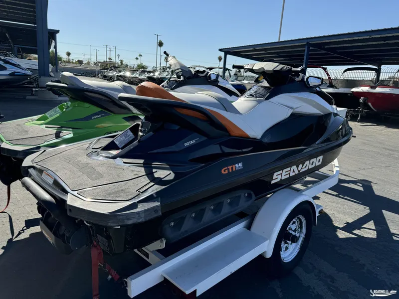 Slide: The Image of 2014 Sea-Doo GTI 155 SE jet ski on trailer in outdoor lot. - 5