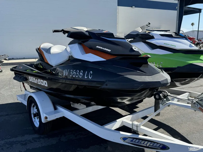 Slide: The Image of 2014 Sea-Doo GTI 130 SE/GTI 155 SE jet ski on trailer, parked outdoors. - 7