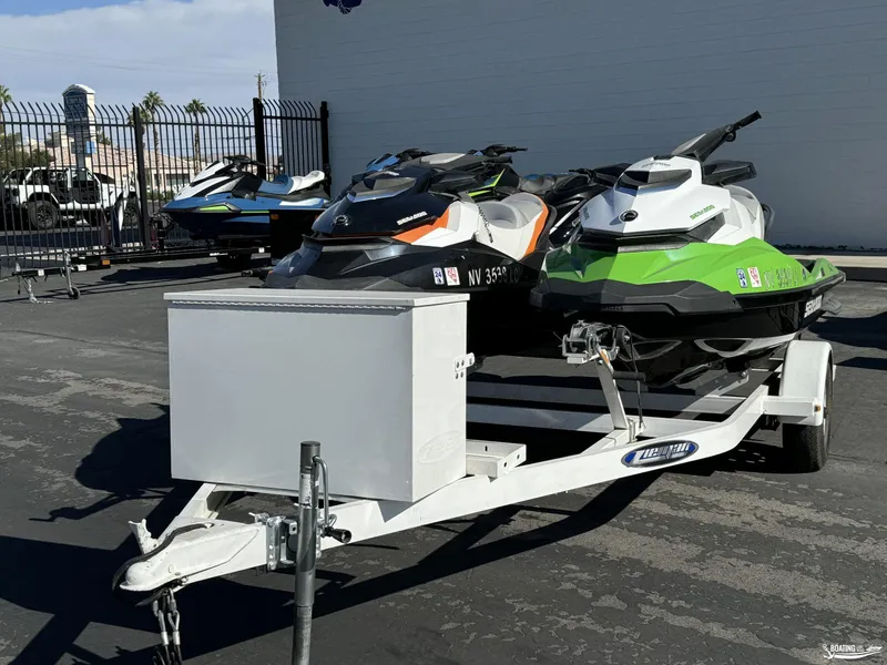 Slide: The Image of 2014 Sea-Doo GTI 130 SE/GTI 155 SE jet skis on a trailer in a parking lot. - 9