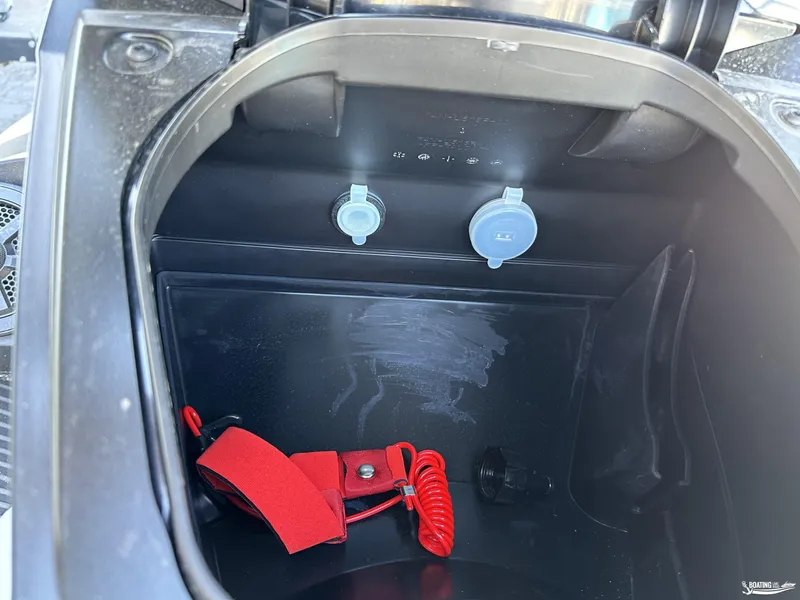 Slide: The Image of 2024 Yamaha WaveRunner VX Cruiser storage compartment with red safety lanyard. - 6