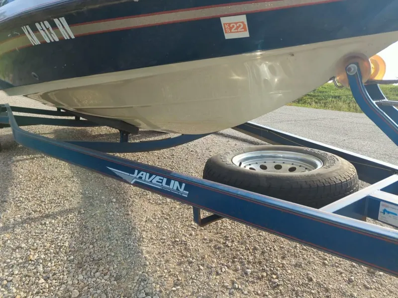Slide: The Image of 1996 Javelin 379 F/S boat on trailer, showing hull and spare tire. - 10