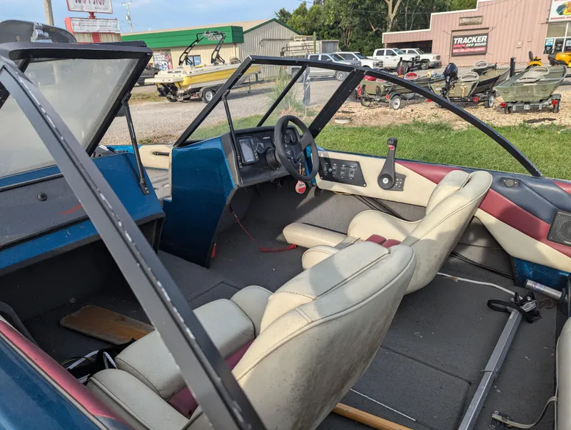 Slide: The Image of Interior of a 1996 Javelin 379 F/S boat with beige and maroon seating. - 12