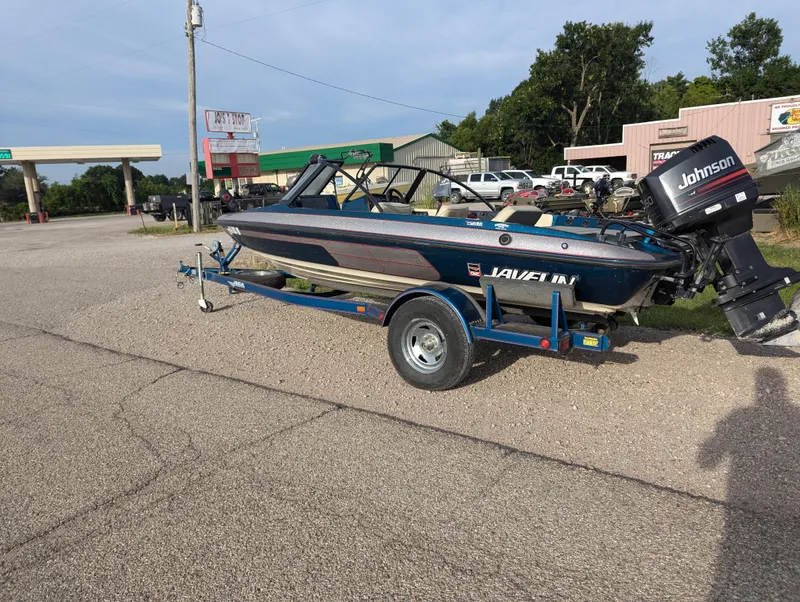 Slide: The Image of 1996 Javelin 379 F/S boat on trailer with Johnson outboard motor in parking lot. - 3