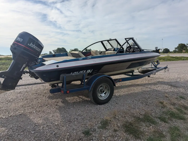 Slide: The Image of 1996 Javelin 379 F/S boat with Johnson 150 outboard motor on trailer. - 7