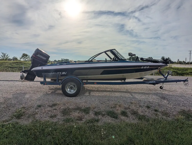 Slide: The Image of 1996 Javelin 379 F/S boat on trailer, parked outdoors under cloudy sky. - 8