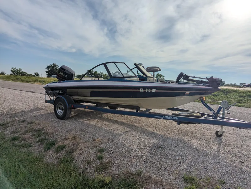 Slide: The Image of 1996 Javelin 379 F/S boat on trailer, parked on gravel road under cloudy sky. - 9