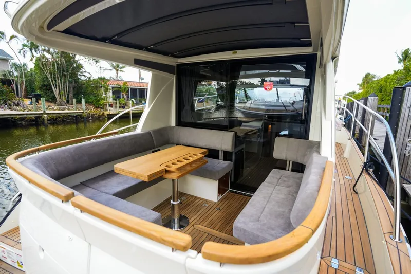 Slide: The Image of 2025 Marex 330 Scandinavia yacht with spacious outdoor seating and wooden table. - 12