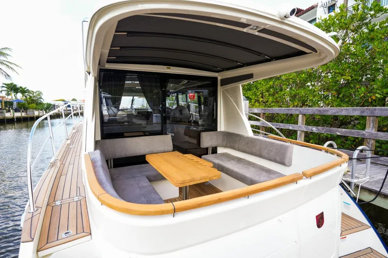 Slide: The Image of 2025 Marex 330 Scandinavia yacht with spacious outdoor seating and wooden table. - 13