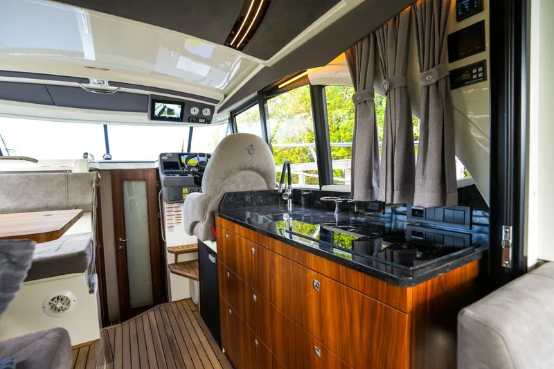 Slide: The Image of Interior of 2025 Marex 330 Scandinavia yacht, featuring modern kitchen and helm area. - 21