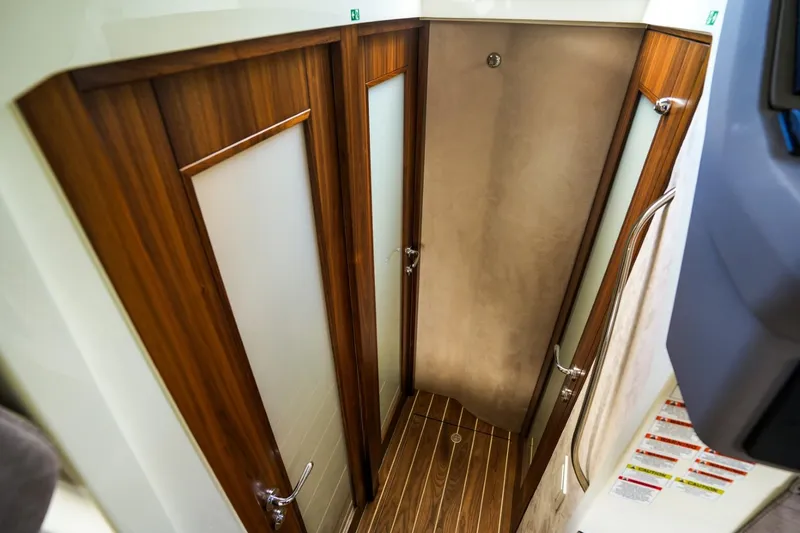 Slide: The Image of Interior of 2025 Marex 330 Scandinavia yacht, featuring elegant wood-finished doors and flooring. - 28