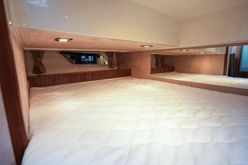 Slide: The Image of Interior cabin of 2025 Marex 330 Scandinavia yacht with cozy bedding and ambient lighting. - 31