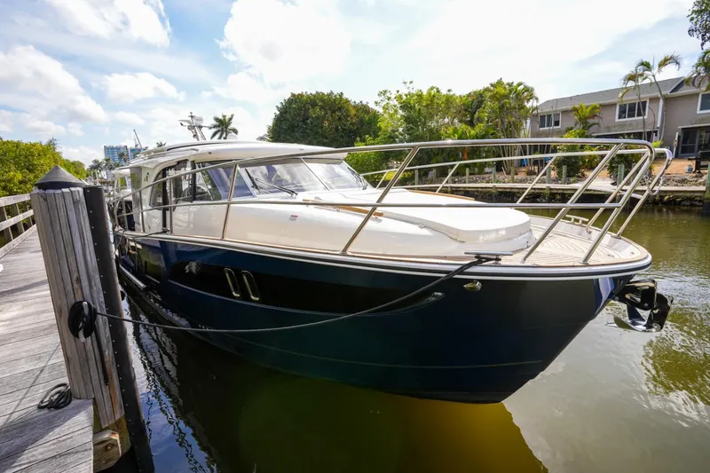 Slide: The Image of 2025 Marex 330 Scandinavia yacht docked by a scenic waterfront. - 42