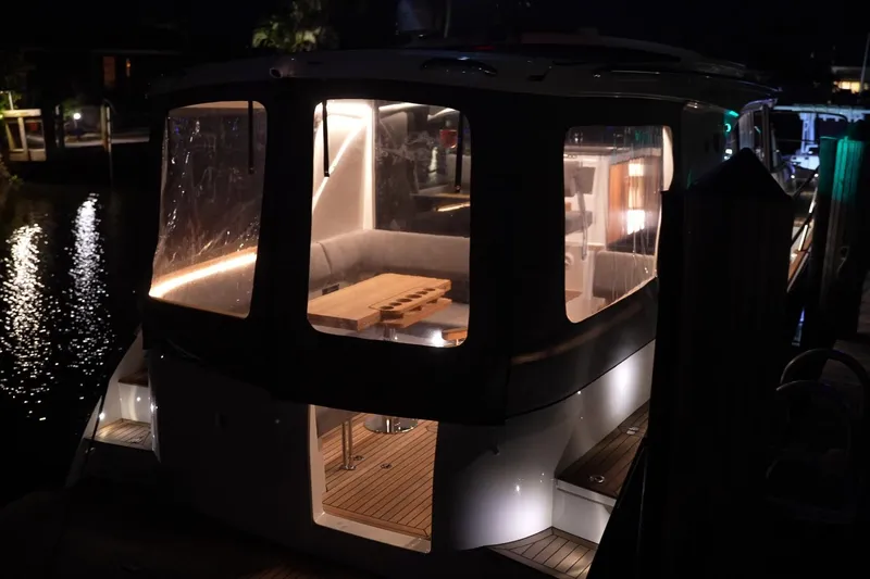 Slide: The Image of Marex 330 Scandinavia 2025 yacht, illuminated interior, docked at night. - 45