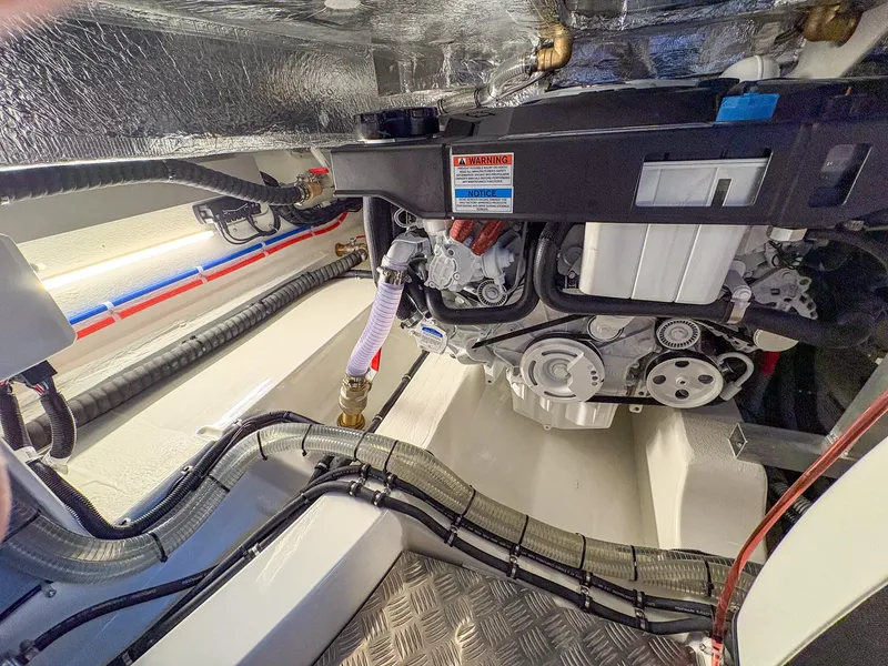 Slide: The Image of Engine compartment of 2025 Marex 330 Scandinavia boat, showcasing mechanical components and wiring. - 47