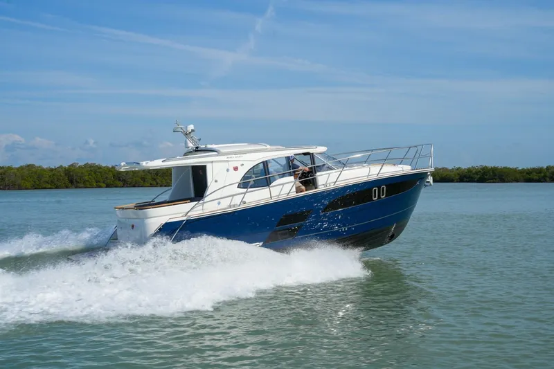 Slide: The Image of 2025 Marex 330 Scandinavia cruising on open water, showcasing sleek design and performance. - 10