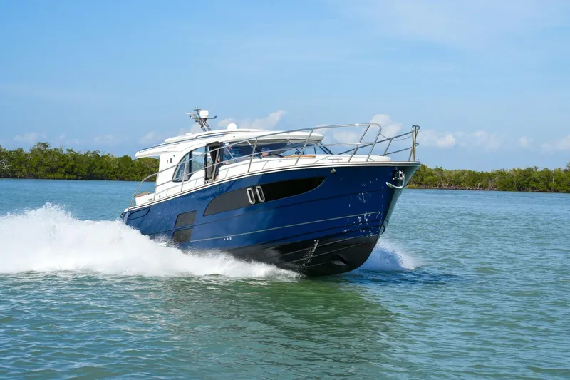 Slide: The Image of 2025 Marex 330 Scandinavia cruising on water, showcasing sleek design and performance. - 11