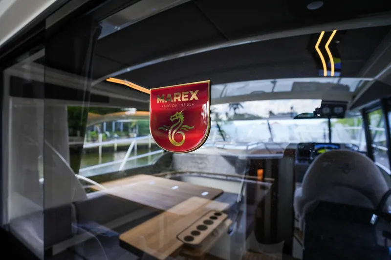 Slide: The Image of 2025 Marex 330 Scandinavia interior view through glass with logo. - 18