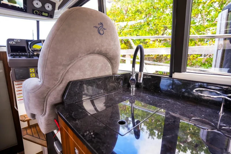 Slide: The Image of Interior of 2025 Marex 330 Scandinavia yacht with sleek kitchen and helm seat. - 24