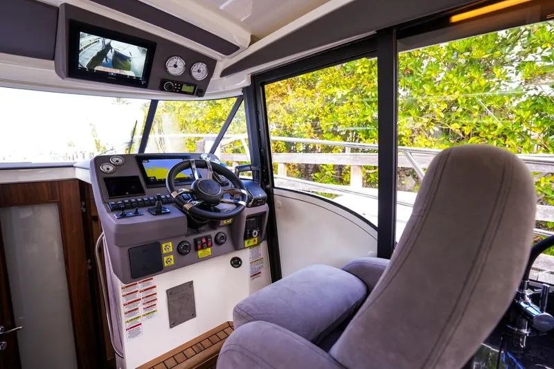 Slide: The Image of Cockpit of 2025 Marex 330 Scandinavia boat with modern controls and comfortable seating. - 25