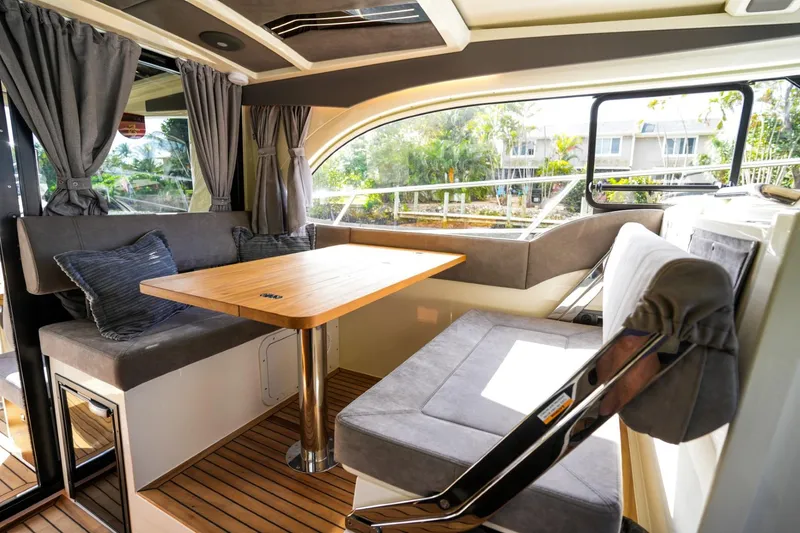 Slide: The Image of 2025 Marex 330 Scandinavia interior with cozy seating and wooden table. - 29