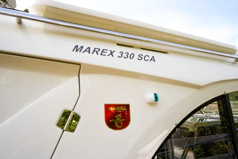 Slide: The Image of 2025 Marex 330 Scandinavia boat side view with logo and model name. - 43