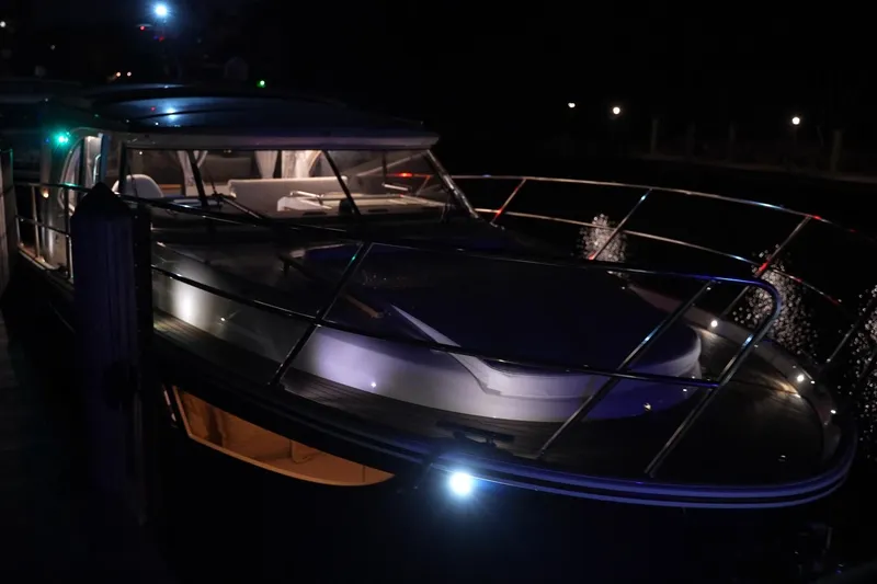 Slide: The Image of 2025 Marex 330 Scandinavia yacht illuminated at night, showcasing sleek design and modern features. - 44