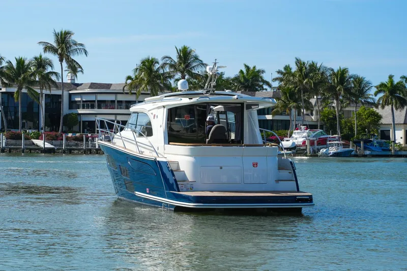 Slide: The Image of 2025 Marex 330 Scandinavia yacht cruising in tropical waters with palm trees in background. - 5